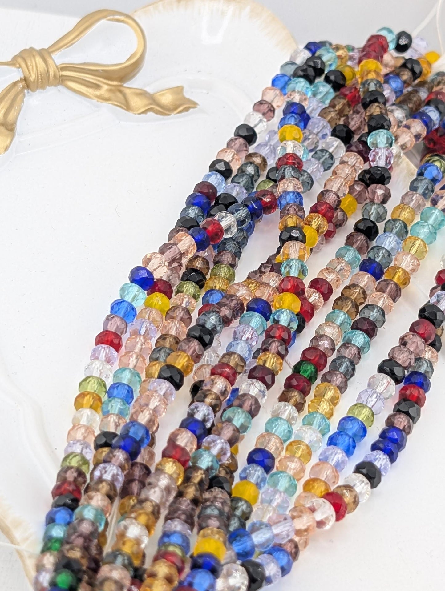 A collection of colorful glass beads in various shapes and sizes, arranged in a visually appealing manner.