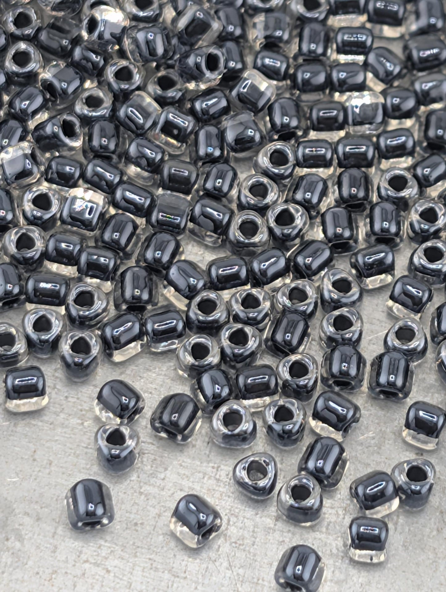 a large number of black and clear beads scattered across a surface.