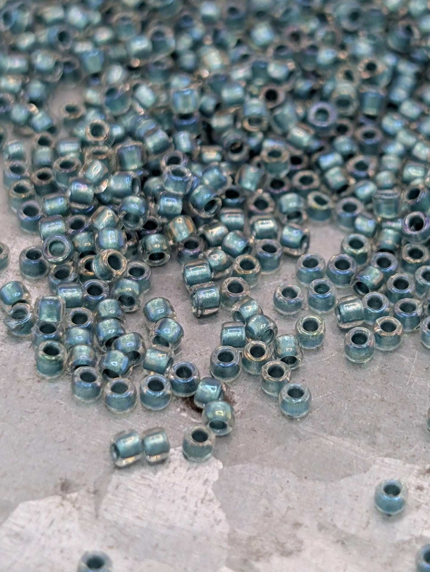 a collection of small, round beads scattered on a surface, with a variety of colors and sizes.