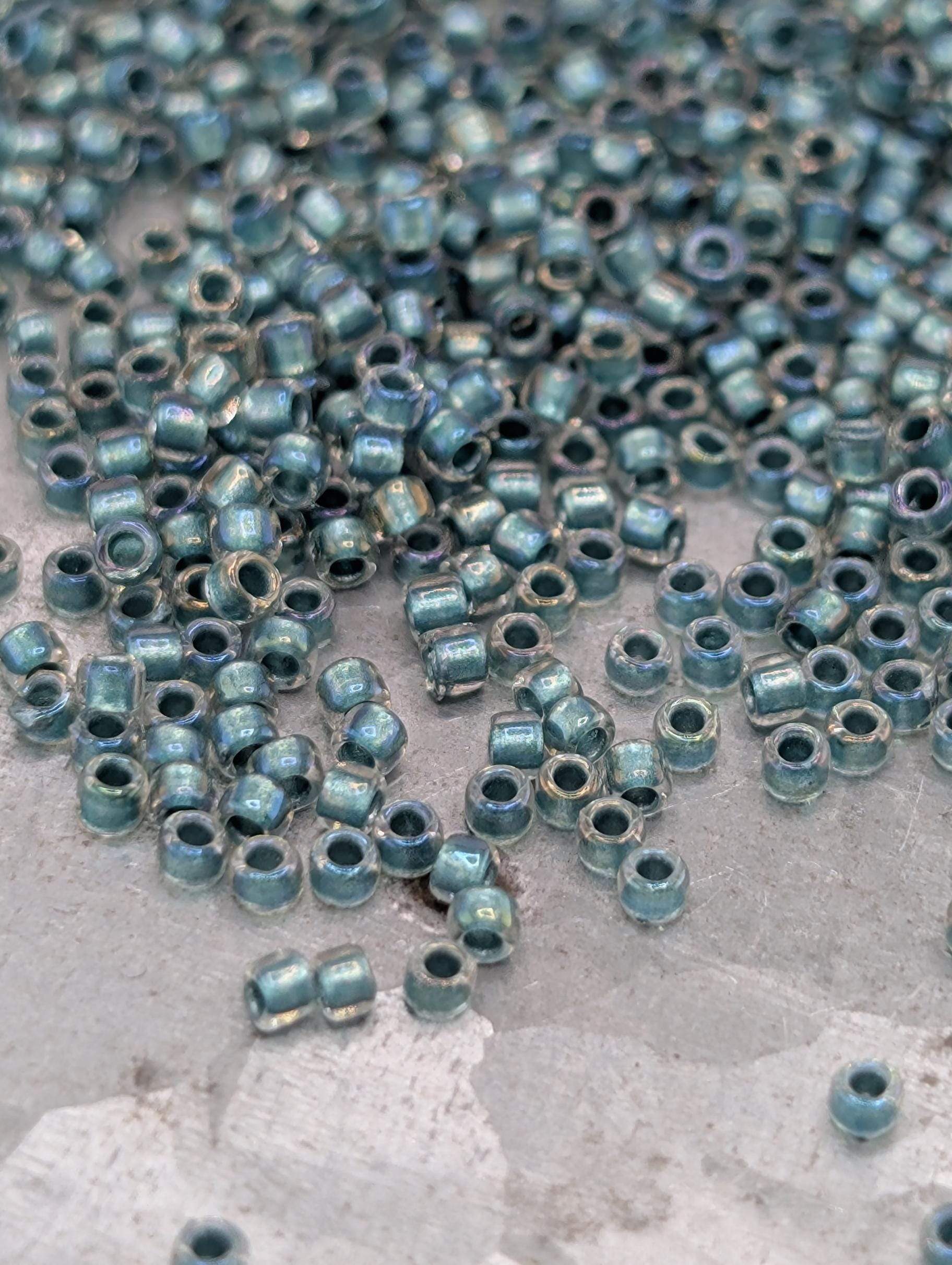 a collection of small, round beads scattered on a surface, with a variety of colors and sizes.