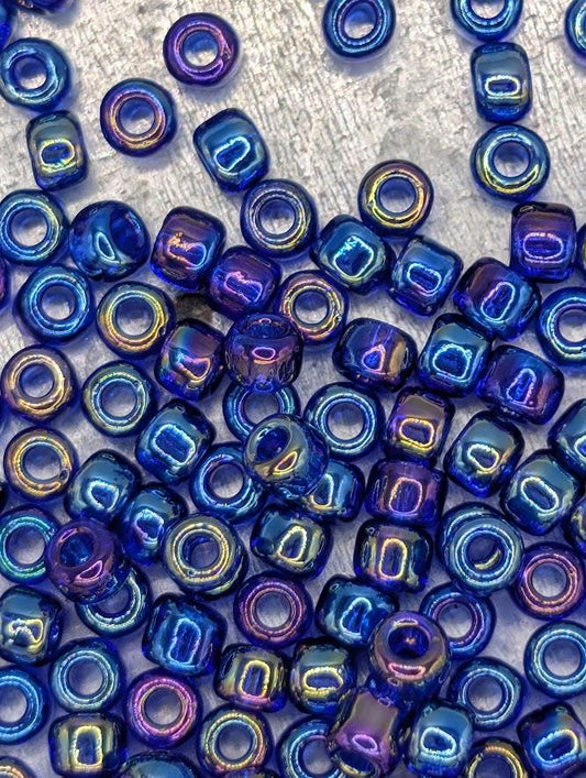 a collection of multicolored glass beads scattered across a surface, with some of the beads reflecting different colors.