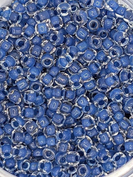 a close-up view of a collection of small, clear beads in various shades of blue, arranged in a visually appealing manner.