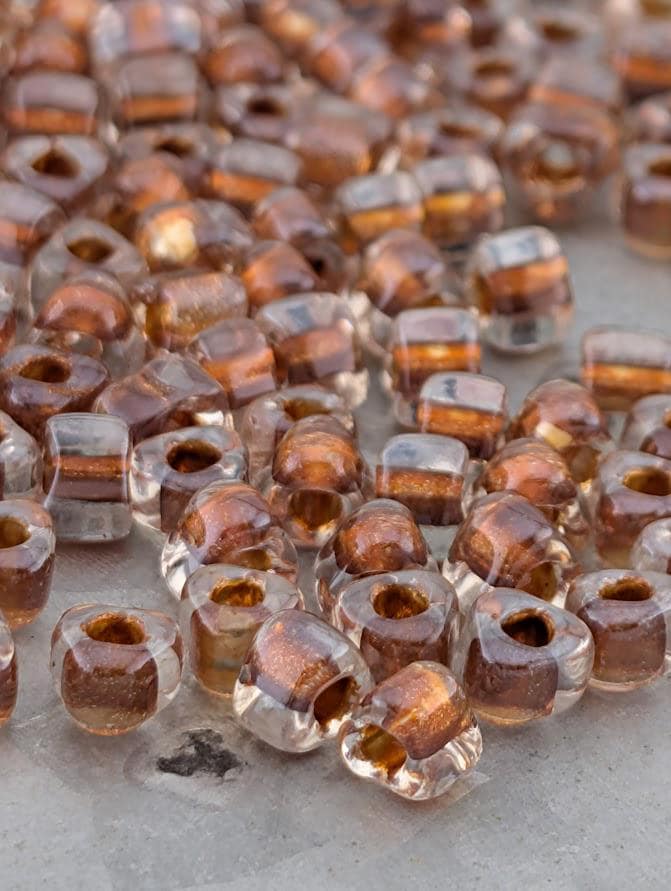 a close-up view of numerous clear glass beads scattered on a surface.