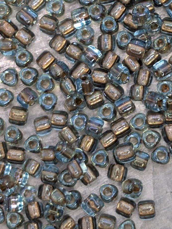 a collection of small, clear glass beads scattered across a surface.