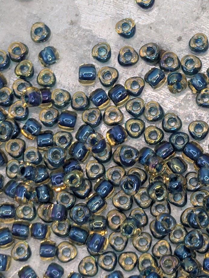 a collection of small, colorful beads scattered on a surface.