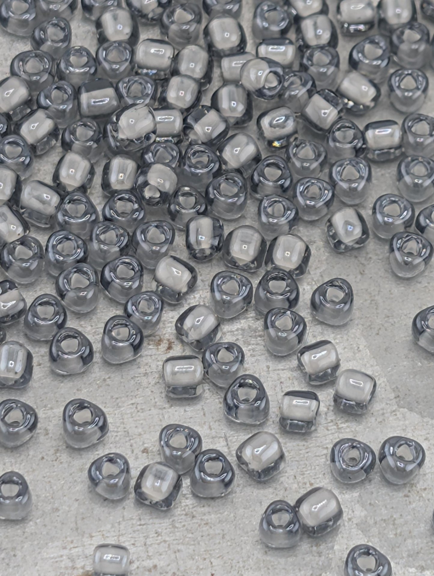 a collection of small, clear beads scattered across a surface.