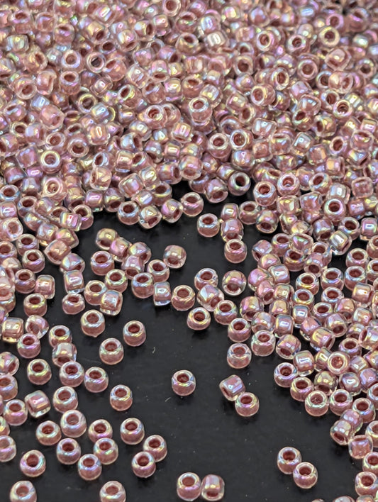 a large number of small, round beads scattered across a dark surface.