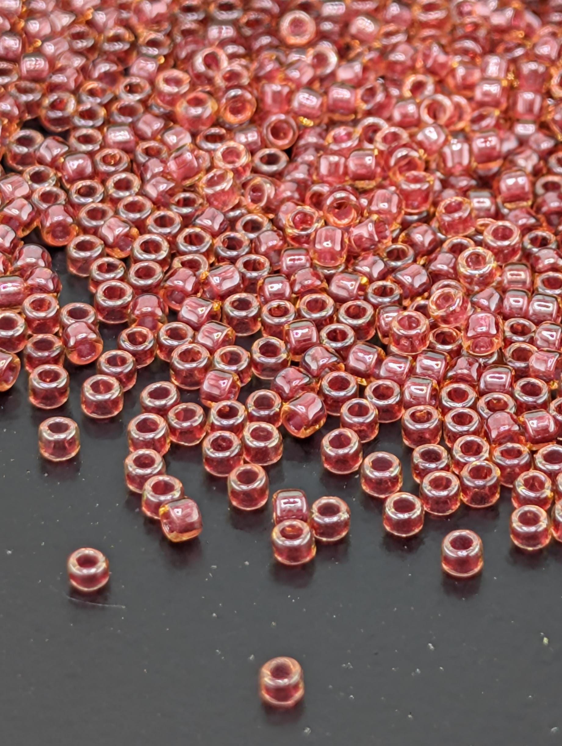 a large number of small, clear beads scattered across a dark surface.