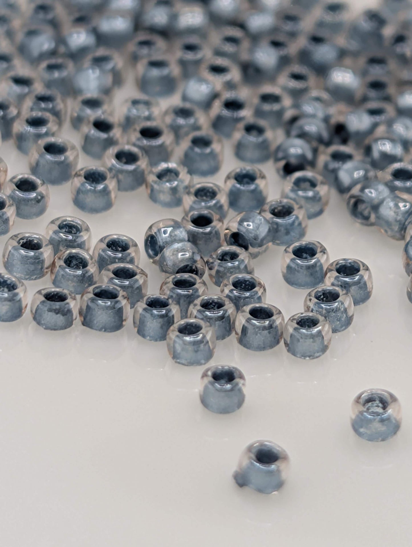a collection of small, clear beads scattered across a white surface.