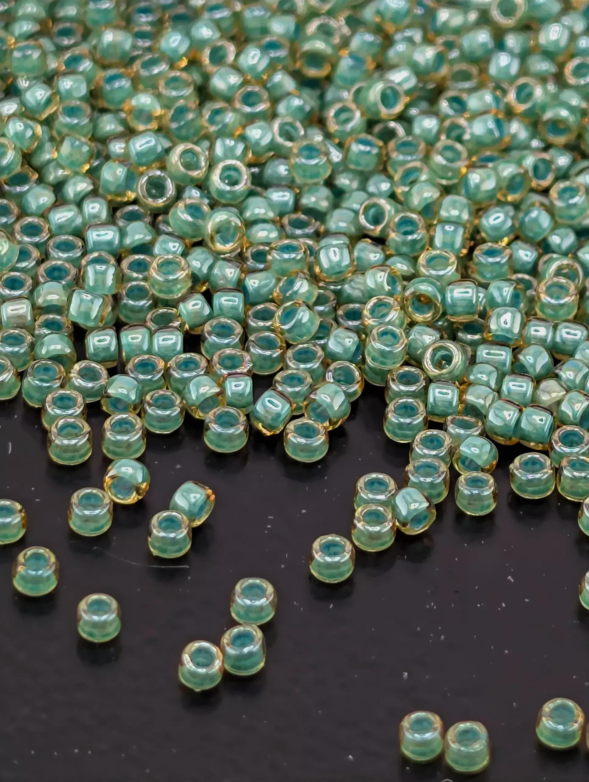 a large number of small, round beads scattered across a dark surface.