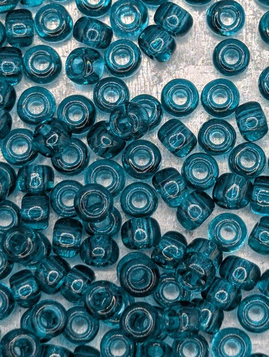 a close-up view of numerous blue glass beads scattered across a surface.