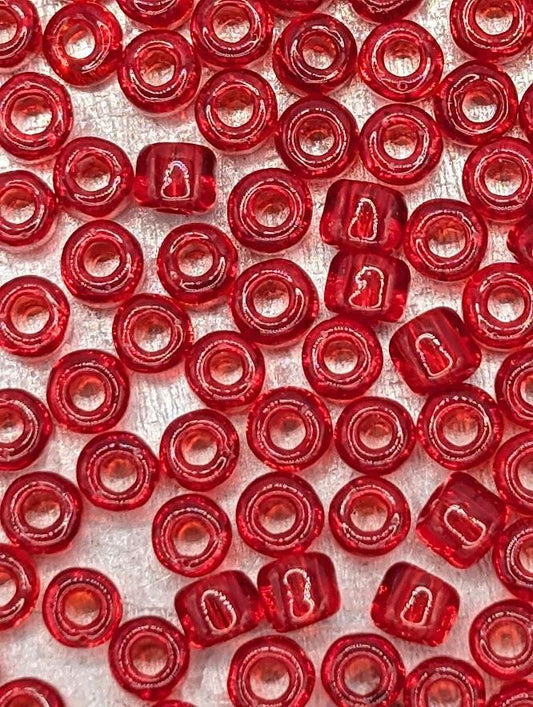 a close-up view of numerous red glass beads arranged in a pattern, creating a visually striking and vibrant display.
