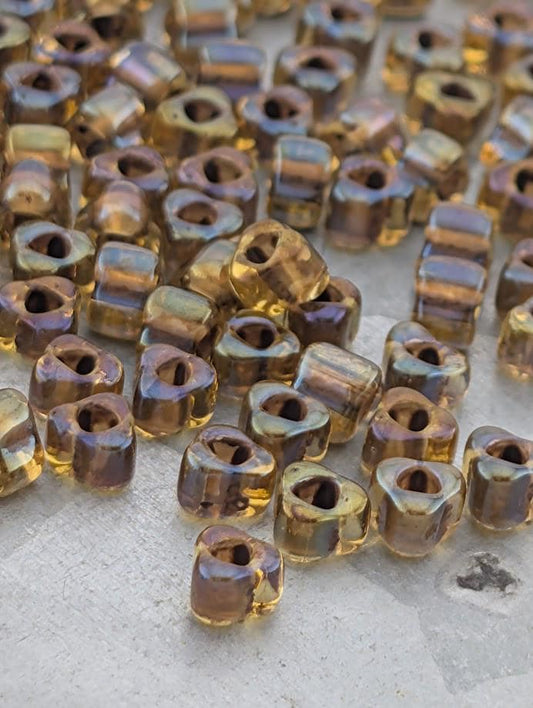 a collection of small, clear beads scattered on a surface.