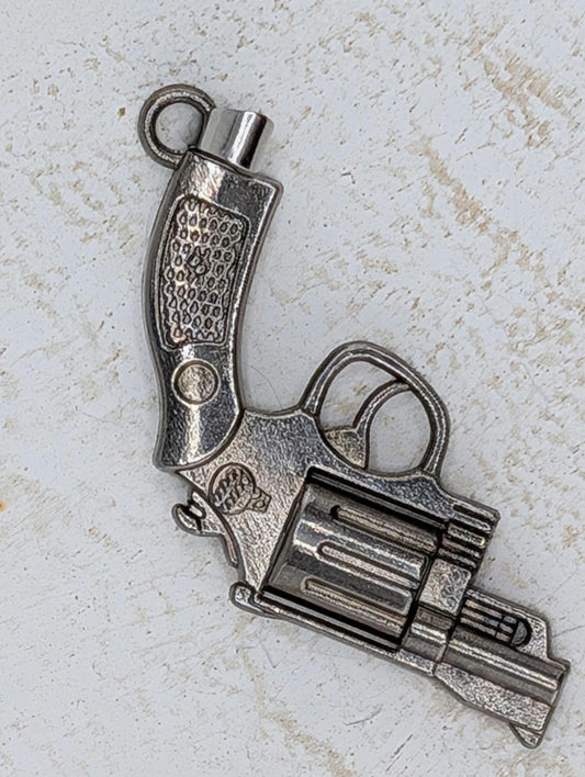 A silver-colored metal toy gun is shown against a white background.