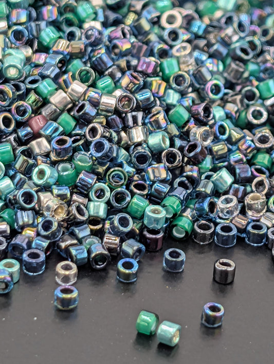 A pile of multicolored glass beads scattered on a dark surface.