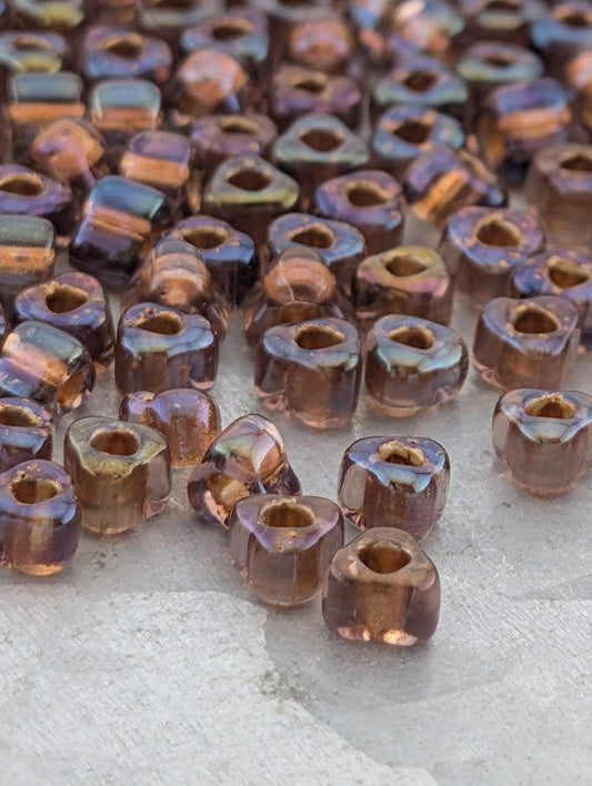 a collection of small, clear beads scattered on a surface.