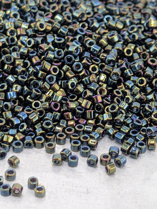 a large pile of multicolored metal nuts or bolts scattered on a surface.