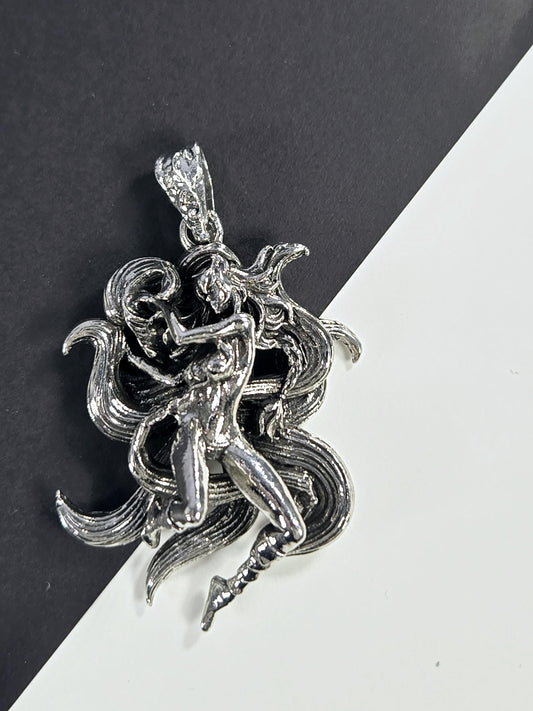 A silver, intricate metal sculpture of a human figure with flowing, organic shapes and a dynamic pose, set against a contrasting black and white background.