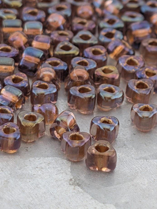 a collection of small, clear beads scattered on a surface.