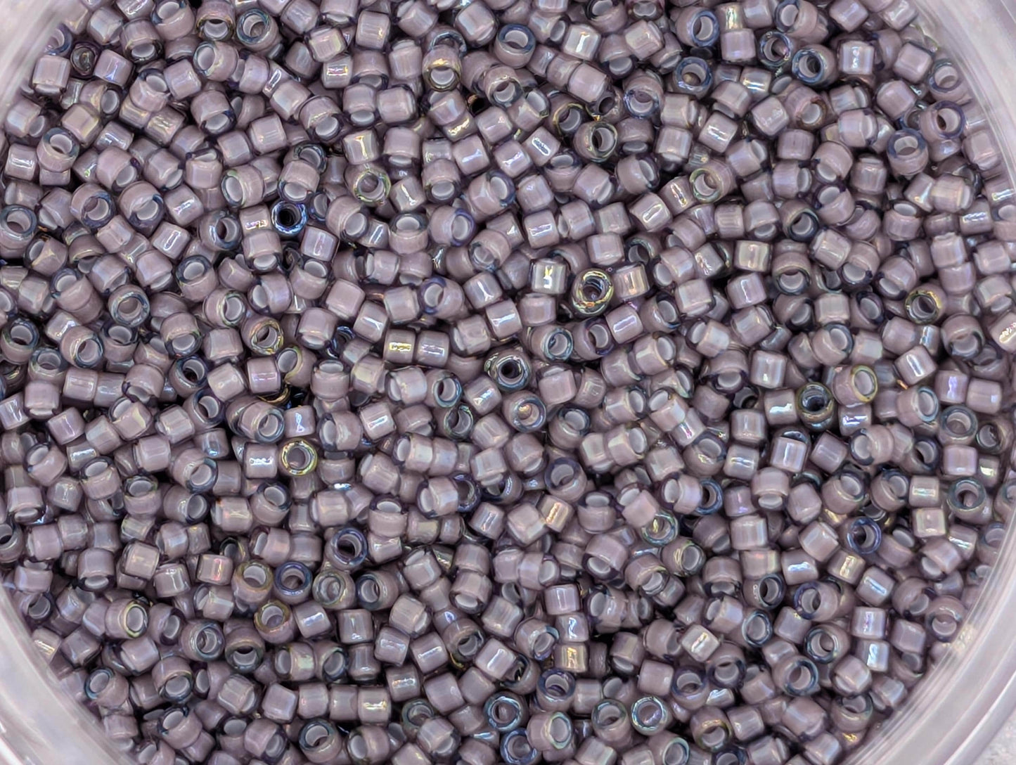 A close-up image of a large pile of small, round beads in various shades of gray.