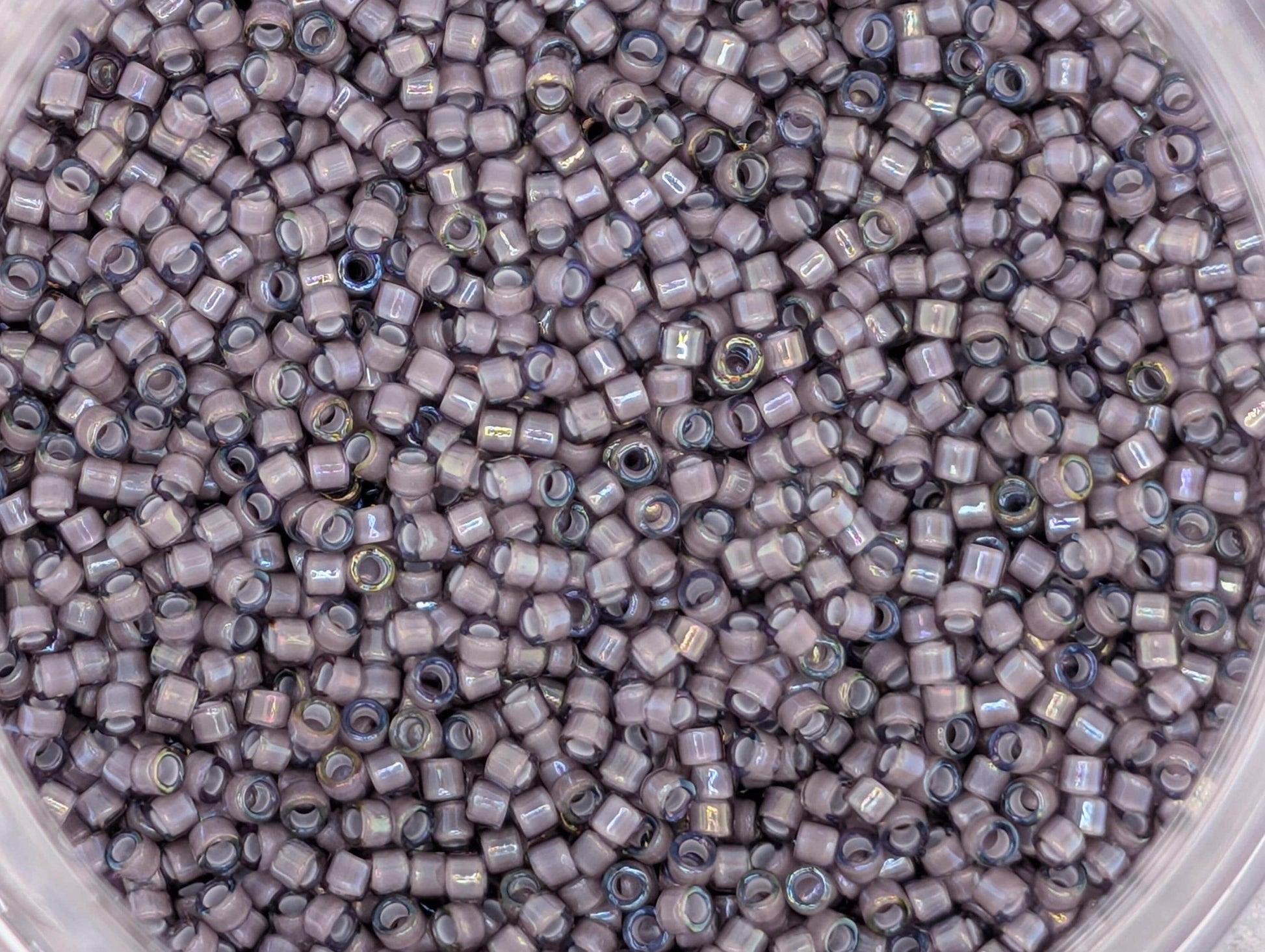 A close-up image of a large pile of small, round beads in various shades of gray.