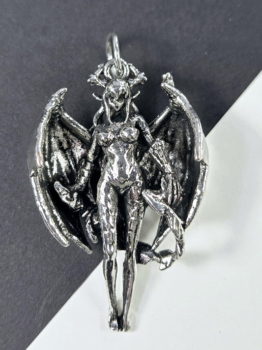 A silver-colored metal sculpture depicting a winged, armored figure with a fierce expression.