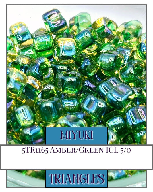a bunch of green and yellow glass beads