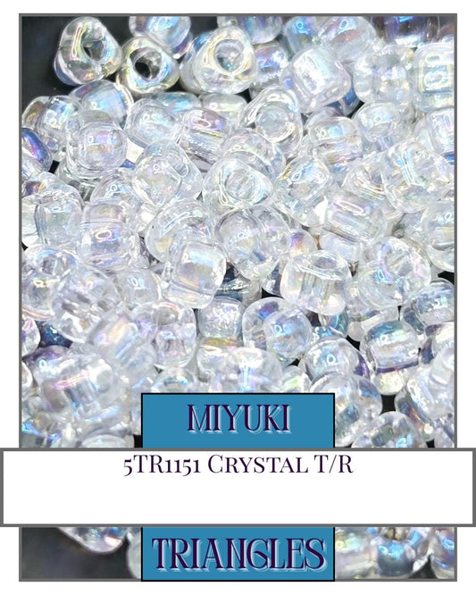 a pile of crystal beads with a blue border