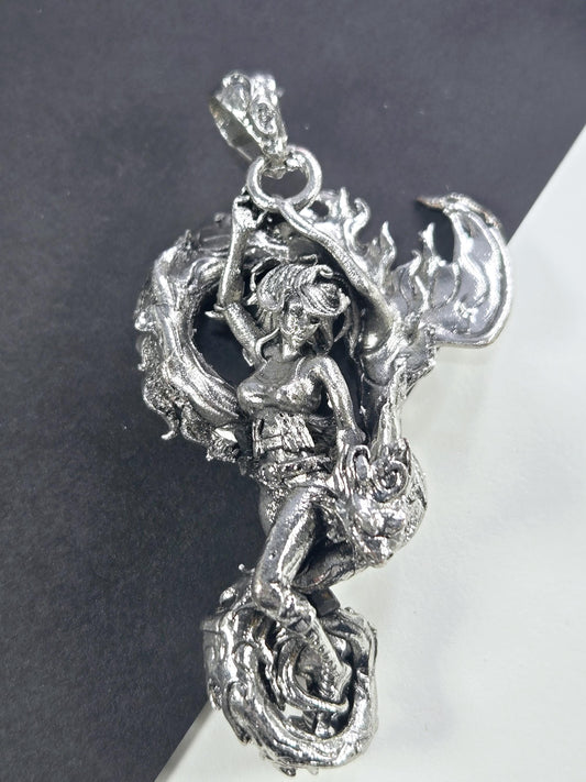A detailed silver sculpture of a dragon-like creature with intricate, flowing designs and a fierce expression.