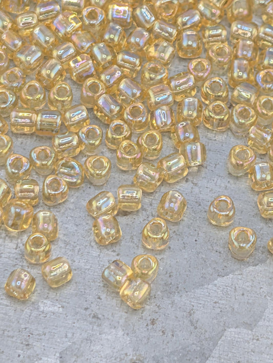 a collection of small, clear beads scattered across a surface, with some of the beads overlapping each other.