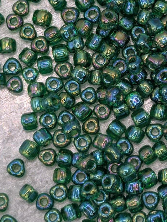 a close-up view of numerous green glass beads scattered across a surface.