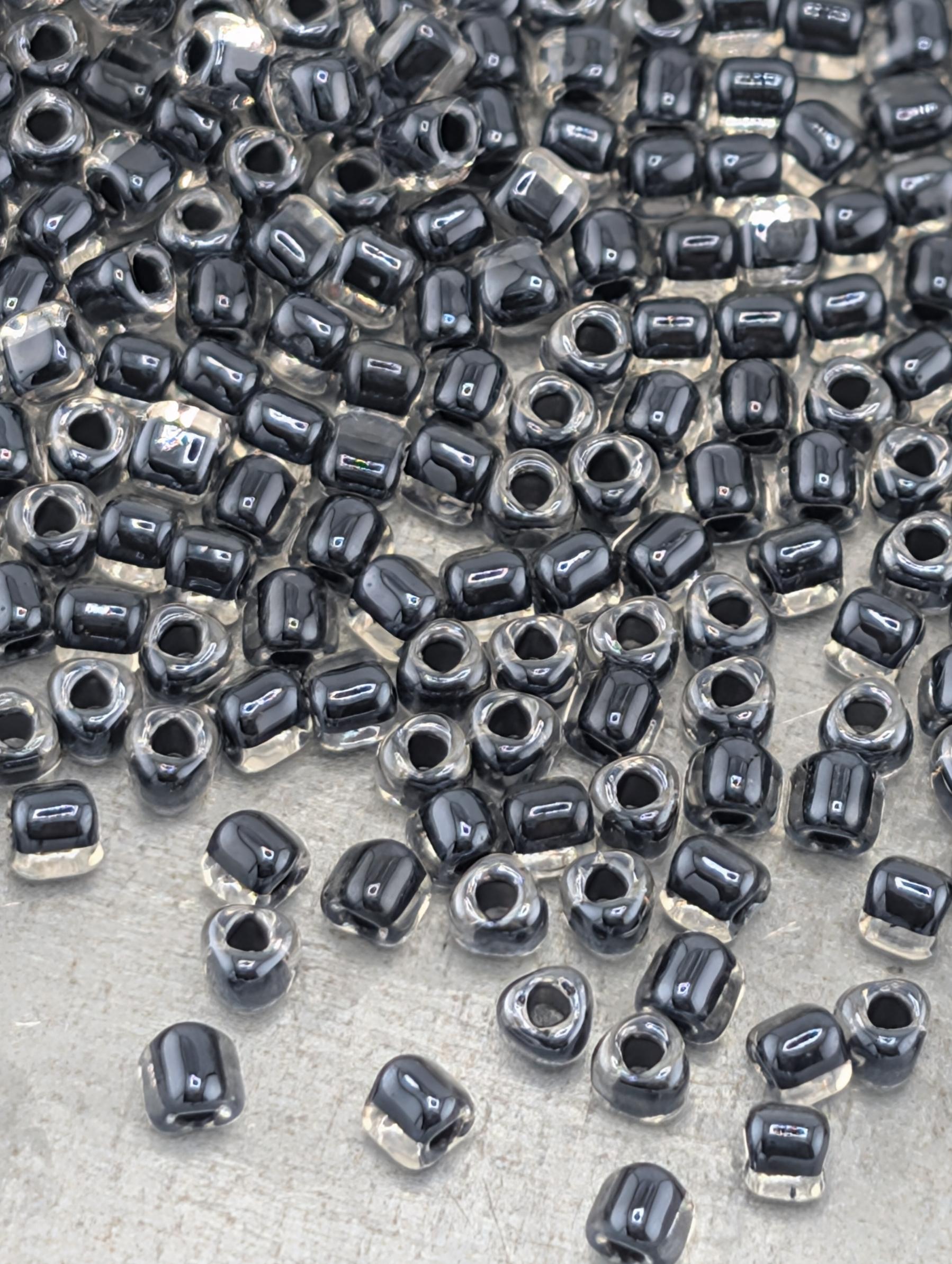 a large number of black and clear beads scattered across a surface.