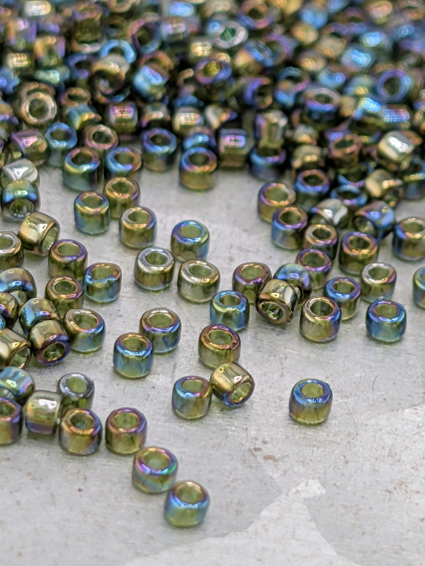 a collection of multicolored glass beads scattered on a surface, with some of the beads overlapping each other.