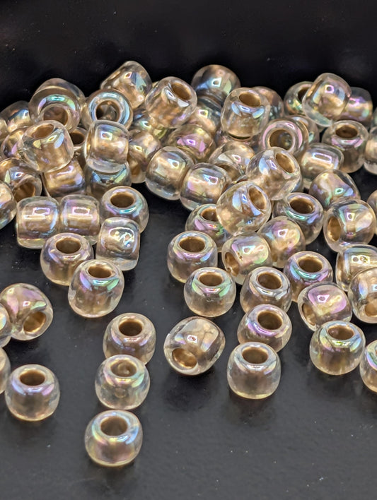 a collection of clear glass beads scattered on a dark surface.