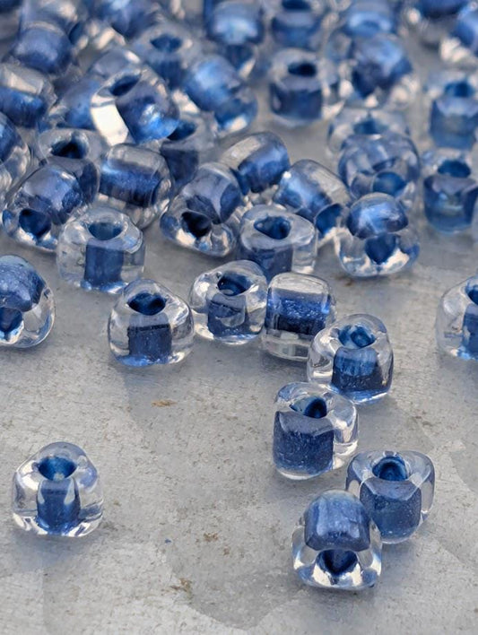 a collection of clear glass beads scattered on a surface, with some of the beads overlapping each other.