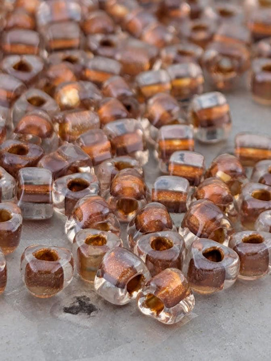 a close-up view of numerous clear glass beads scattered on a surface.