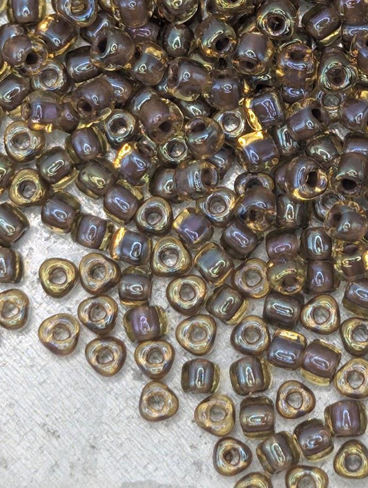 a collection of small, round beads scattered on a surface, with a variety of colors and sizes.