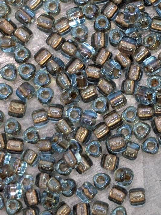 a collection of small, clear glass beads scattered across a surface.