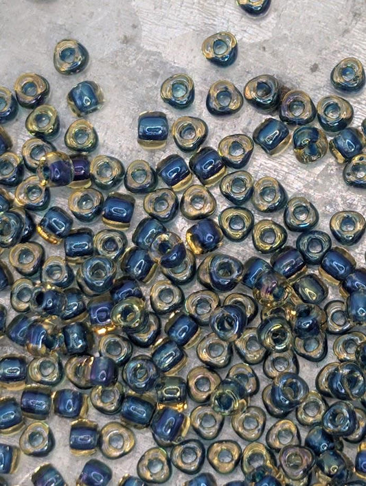 a collection of small, colorful beads scattered on a surface.
