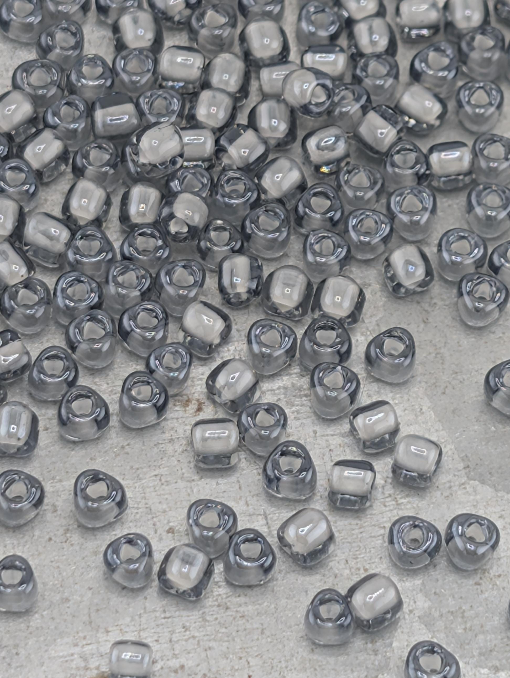a collection of small, clear beads scattered across a surface.