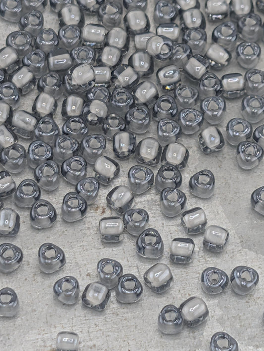 a collection of small, clear beads scattered across a surface.